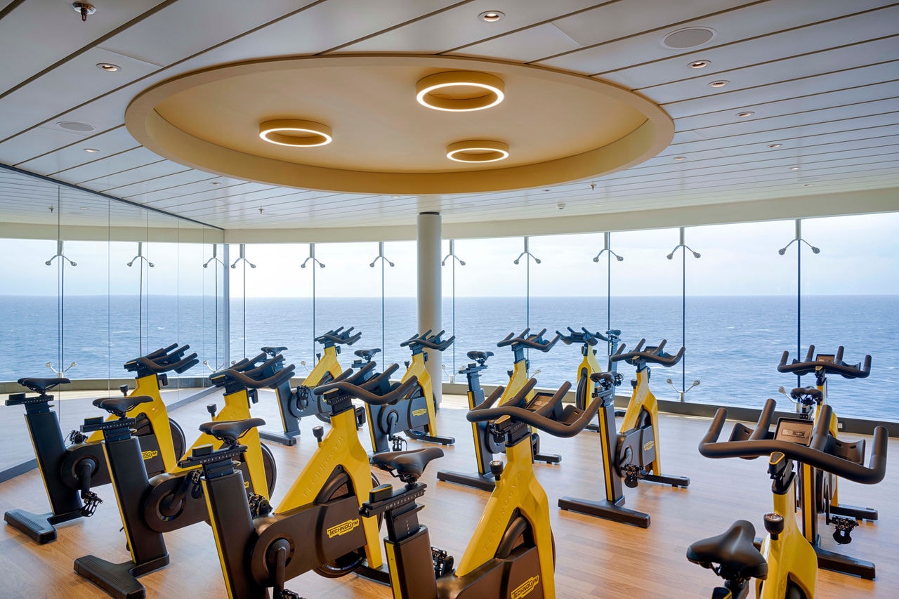 Modern gym with exercise bikes and panoramic sea views for energizing workouts onboard | MSC Cruises