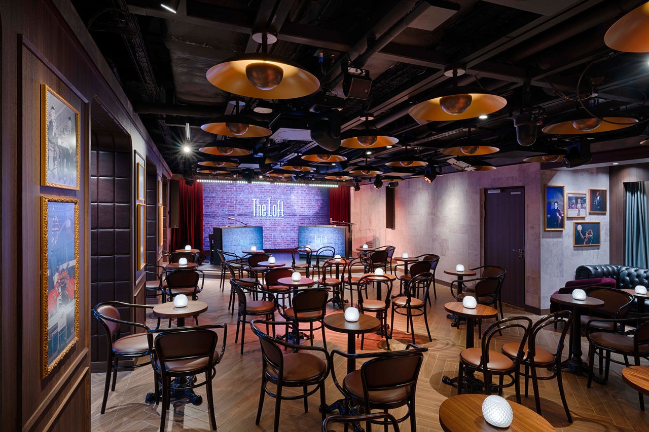 Lounge with armchairs and stage for comedy and live music aboard MSC World America | MSC Cruises