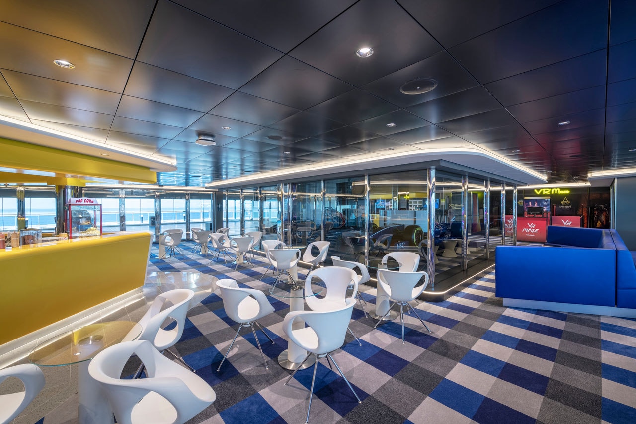 Relaxation area featuring modern seating and interactive entertainment aboard MSC Bellissima | MSC Cruises