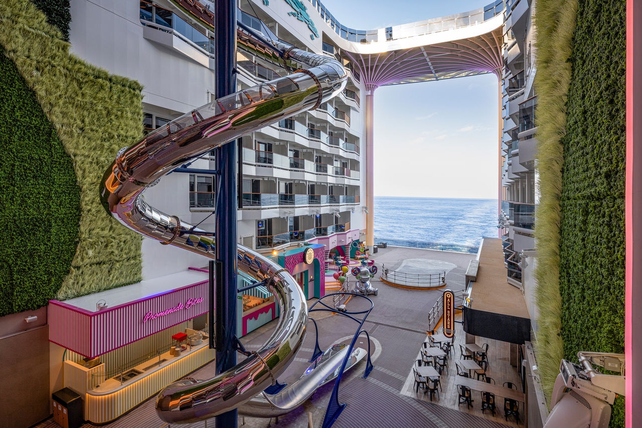 Spacious seating area with slide and sea view on MSC World America ship | MSC Cruises