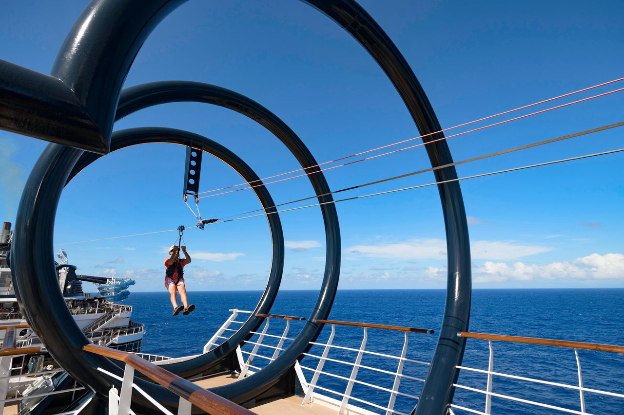 An exhilarating zip line adventure on the deck overlooking the sea and vibrant blue sky | MSC Cruises